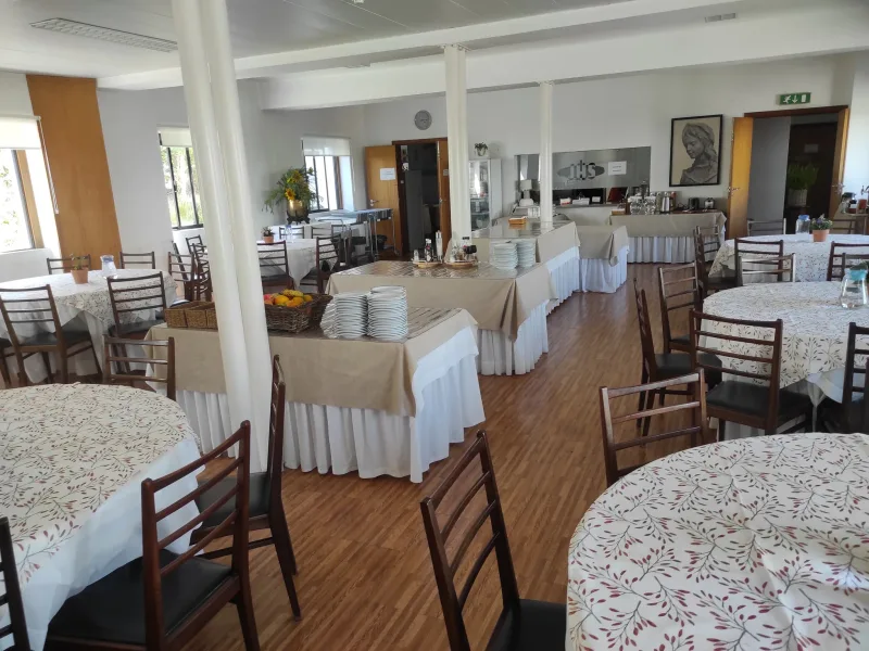The dining hall set with round tables for shared meals
